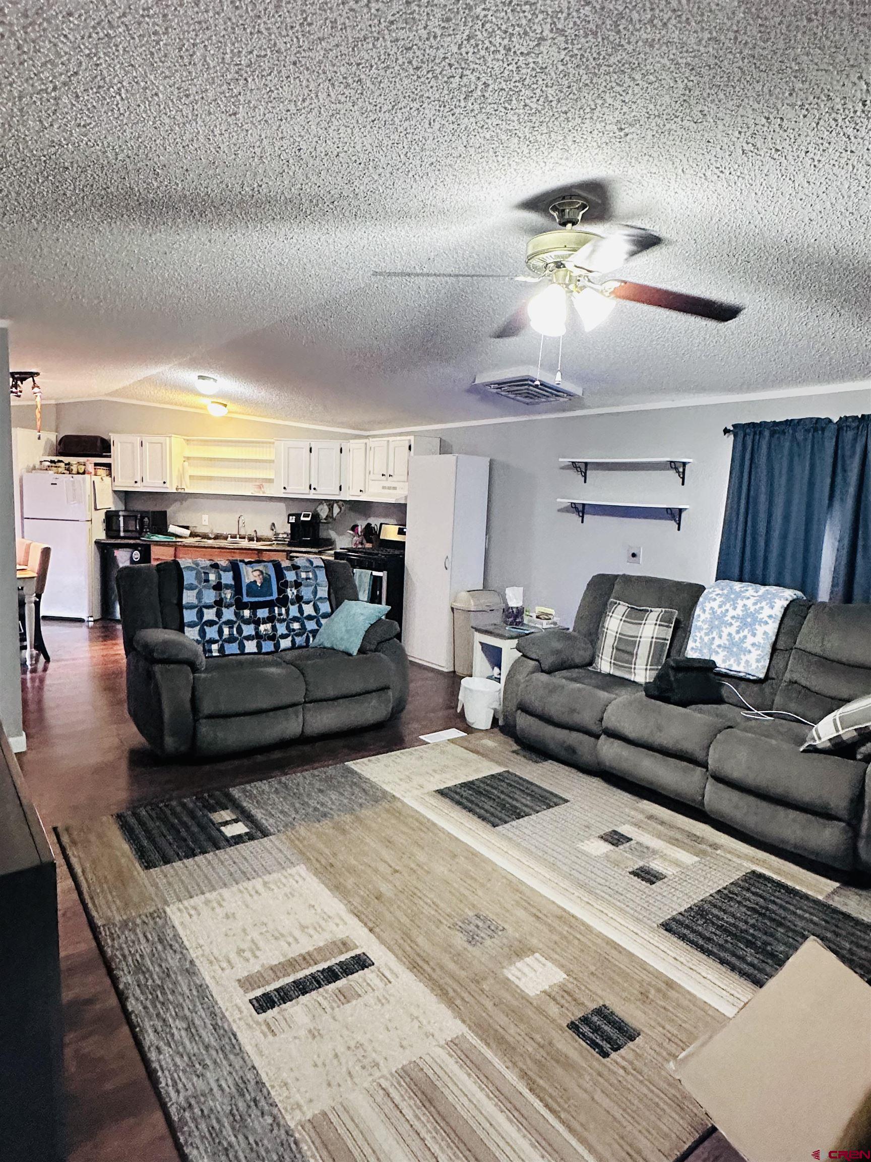 62880 Lasalle Road, Unit 174 Montrose, CO 81401 - Photo 9 of 23 a living room with furniture and a table