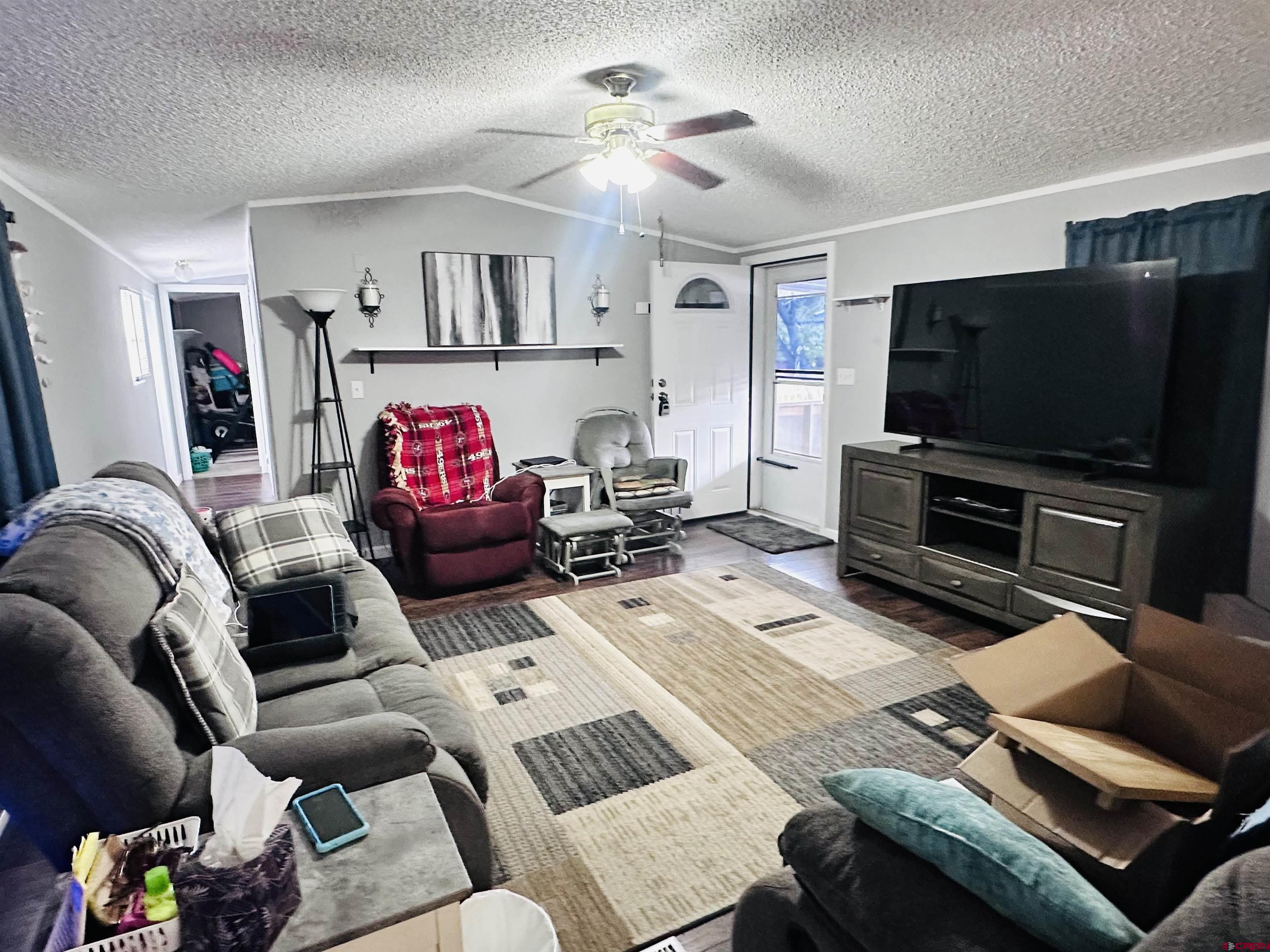 62880 Lasalle Road, Unit 174 Montrose, CO 81401 - Photo 10 of 23 a living room with furniture and a flat screen tv