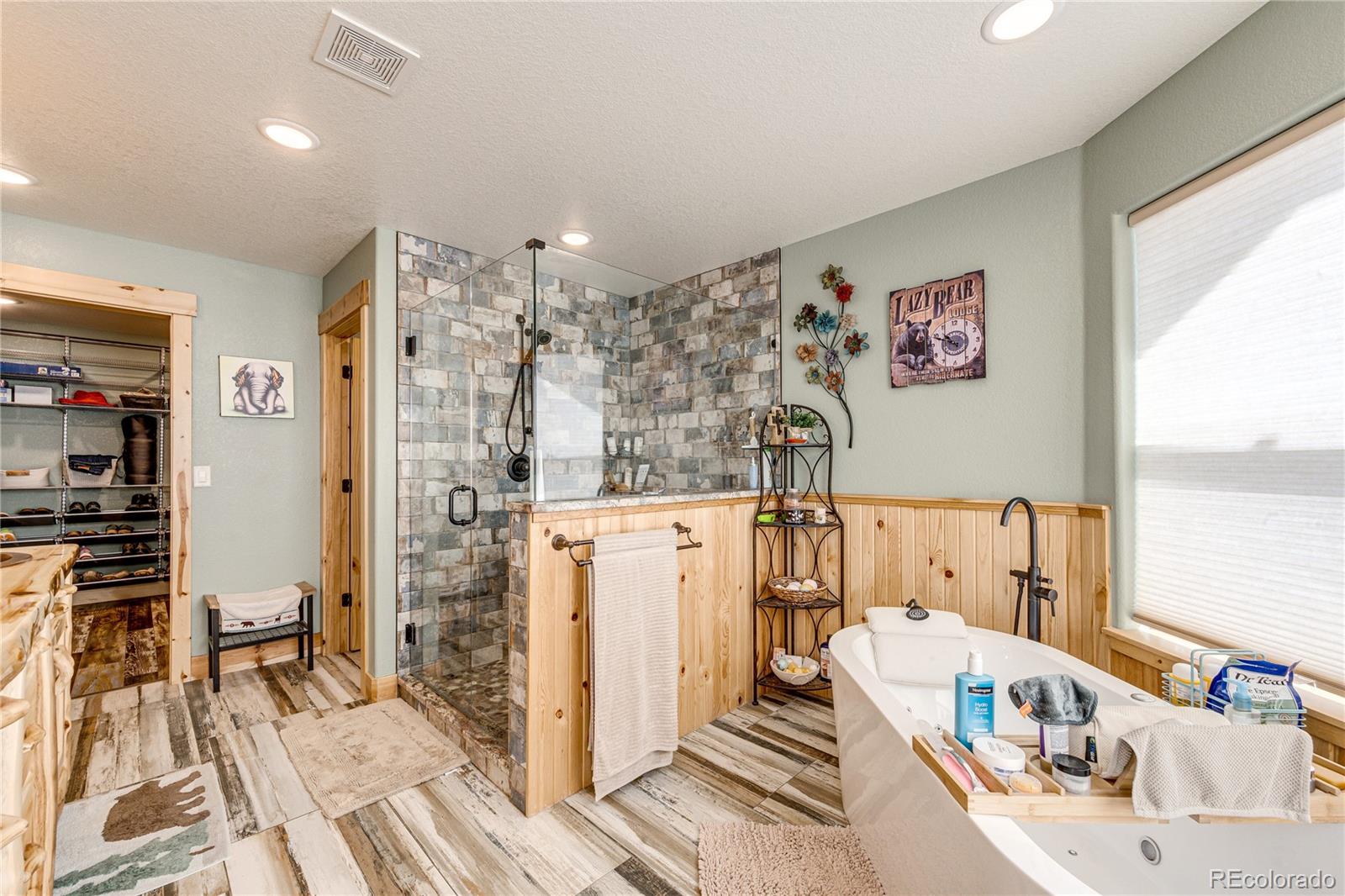 3955 South Behrens Road Byers, CO 80103 - Photo 15 of 32 a bathroom with a sink a mirror and shower