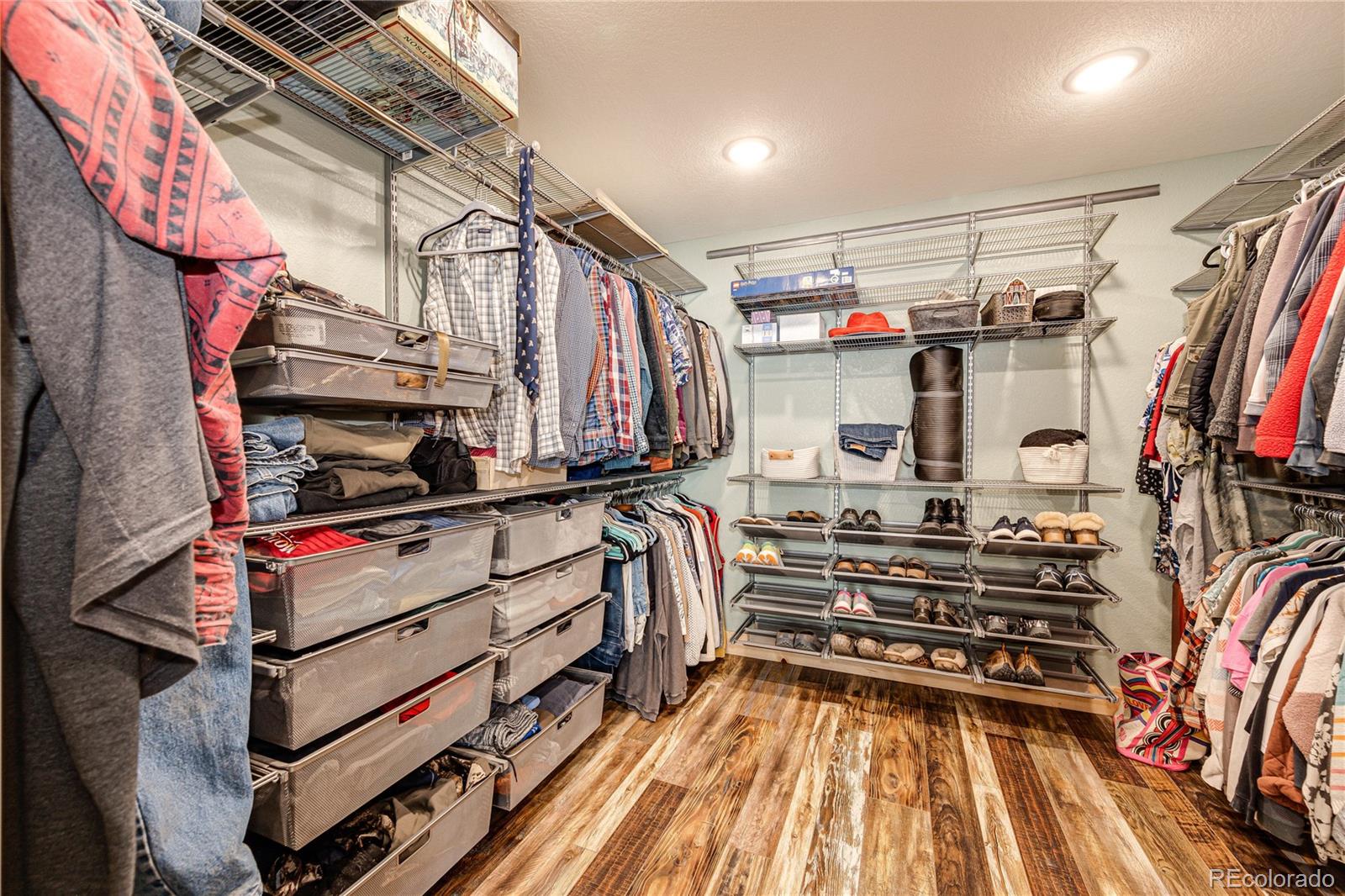 3955 South Behrens Road Byers, CO 80103 - Photo 18 of 32 a view of walk in closet with clothes and shoes