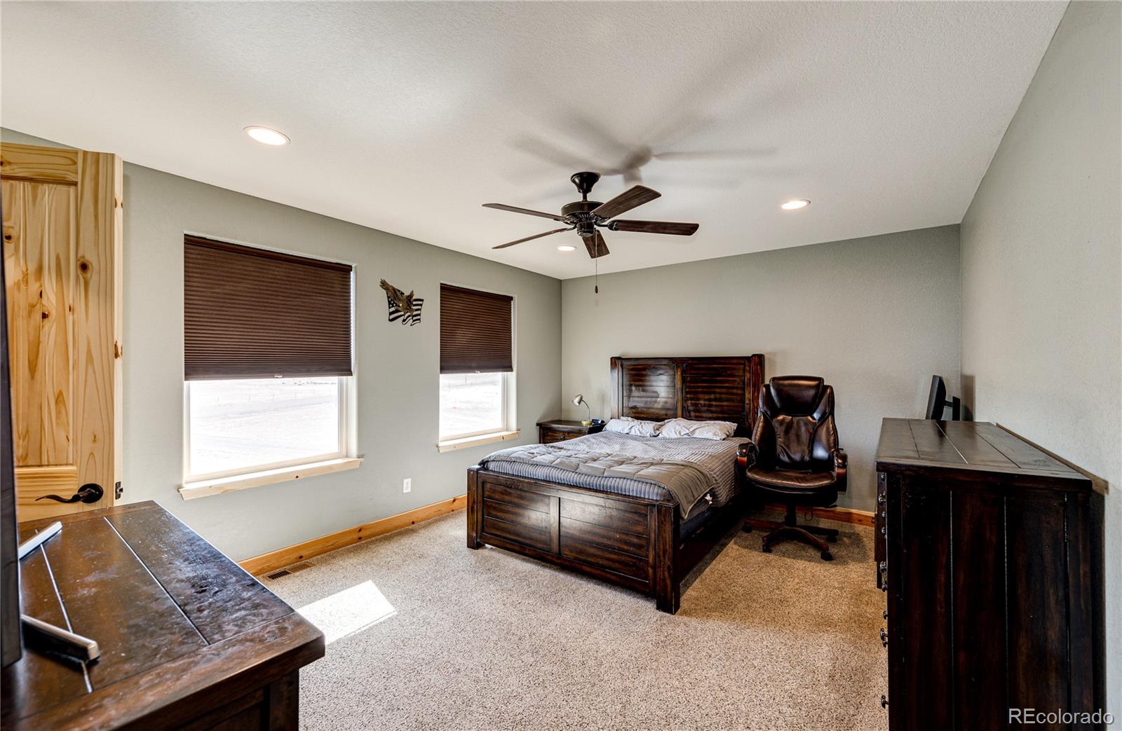 3955 South Behrens Road Byers, CO 80103 - Photo 20 of 32 a bedroom with a bed and a window