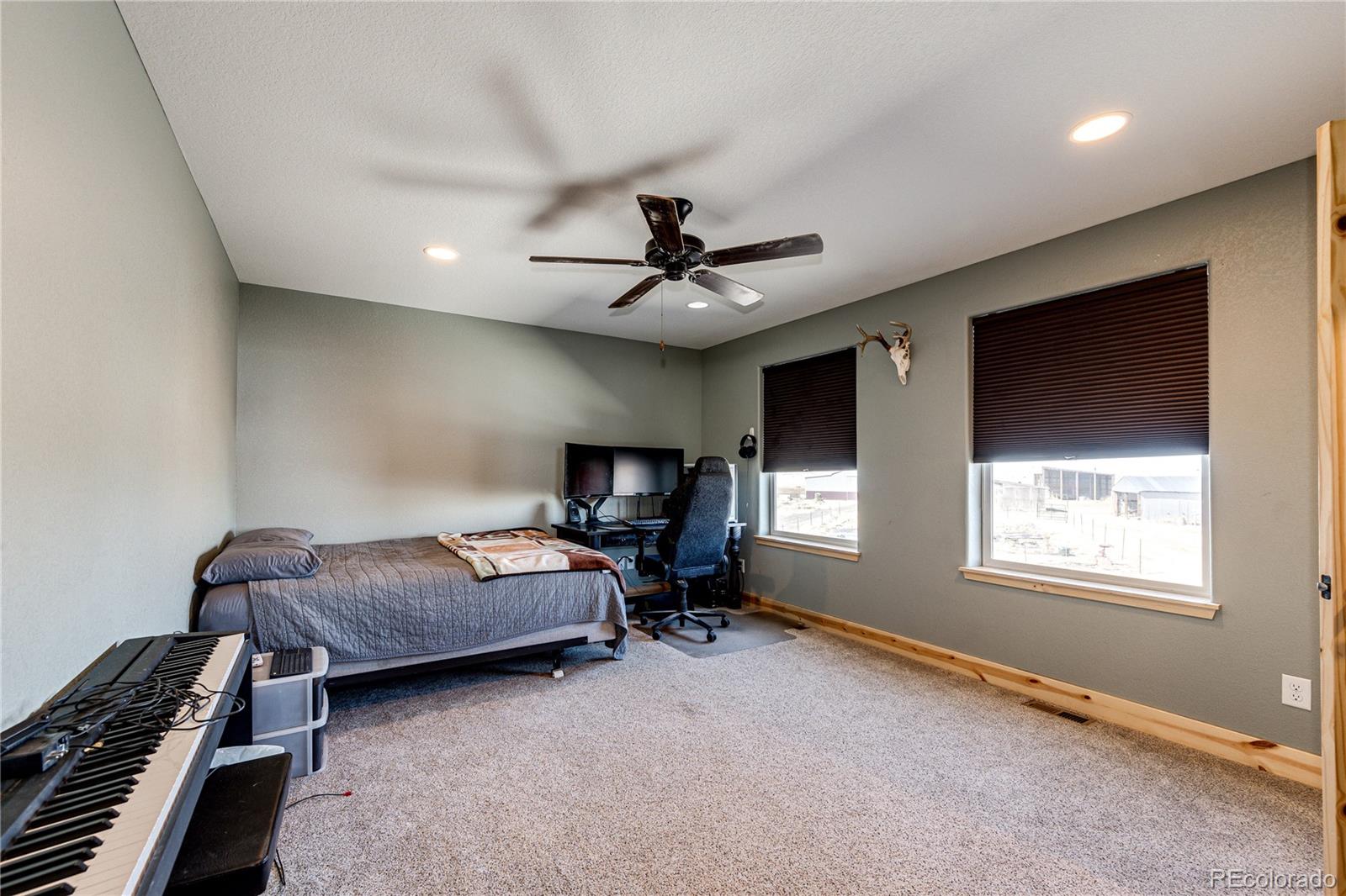 3955 South Behrens Road Byers, CO 80103 - Photo 21 of 32 a bedroom with furniture and a window