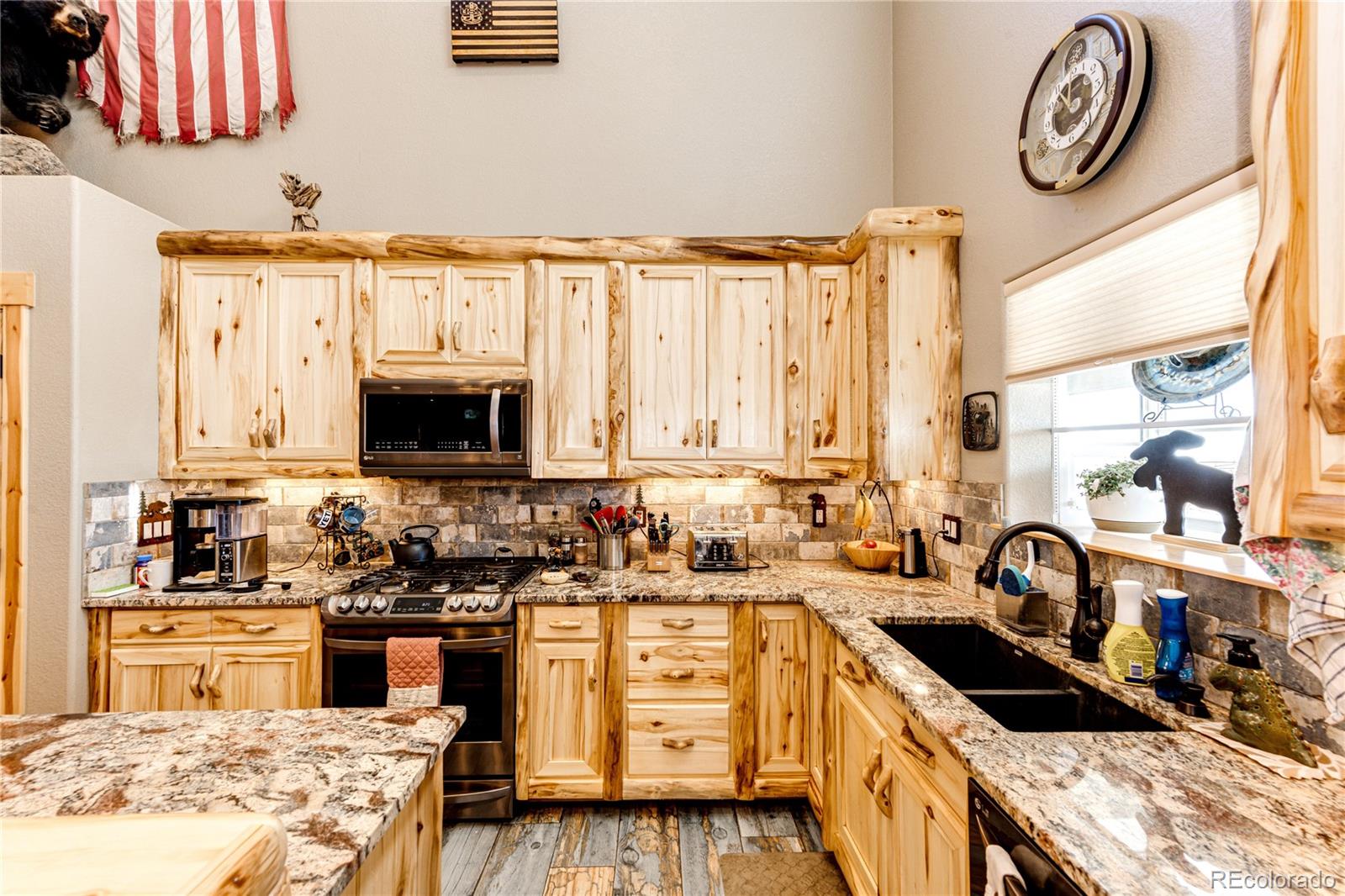 3955 South Behrens Road Byers, CO 80103 - Photo 7 of 32 a kitchen with kitchen island granite countertop a sink and a stove top oven