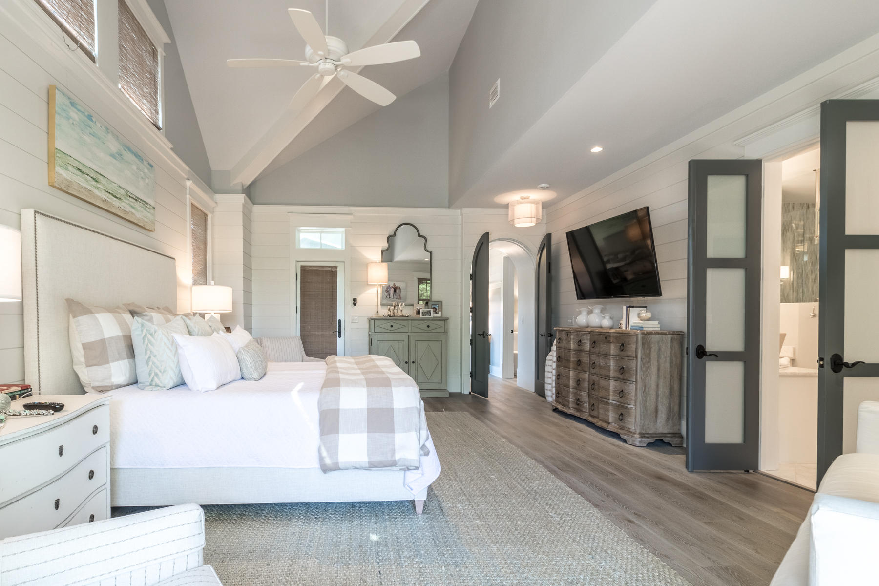 52 North Shingle Way Inlet Beach, FL 32461 - Photo 15 of 49 a spacious bedroom with a large bed a flat tv screen and a chandelier