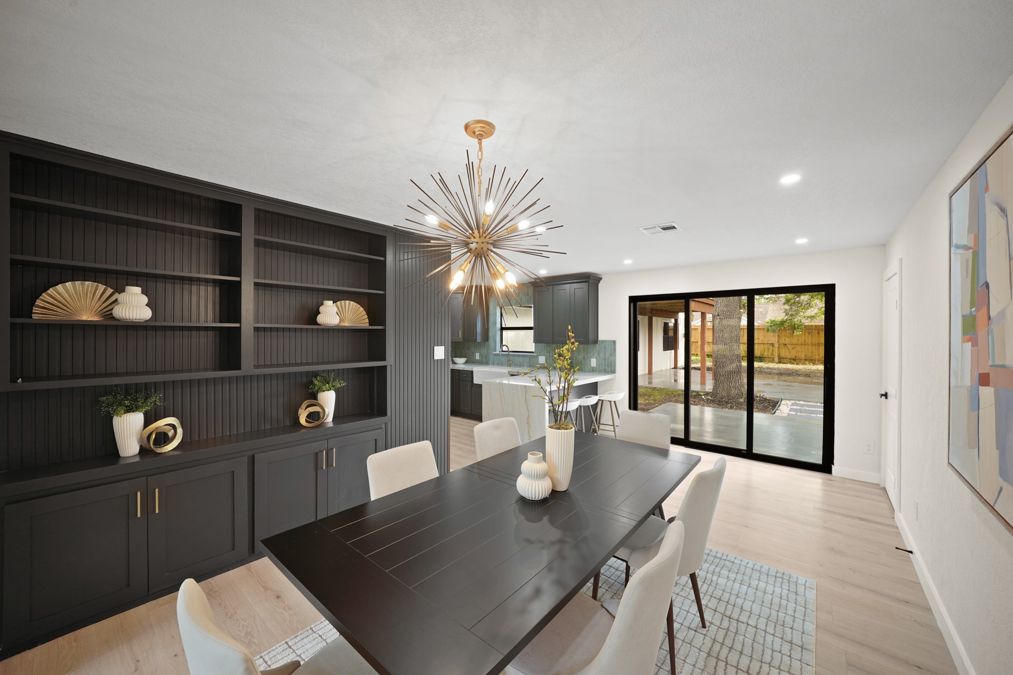 4813 Hummingbird Street Houston, TX 77035 - Photo 6 of 50 Enjoy serving Festive Family Meals in the Dining Area (North Wing) that boasts a Sputnik Contemporary Style Edison Bulb Chandelier with Brushed Natural Brass---such a Gorgeous Focal Point for the Room! Triple Sliding Glass Doors open to the Expansive Outdoor Living Area and to the Spacious Fenced Yard.