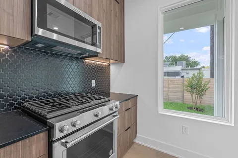 a stove top oven sitting inside of a kitchen