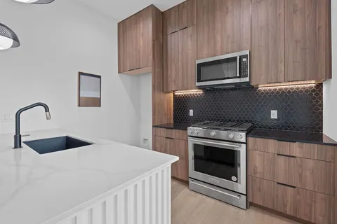 a kitchen with a stove microwave and sink