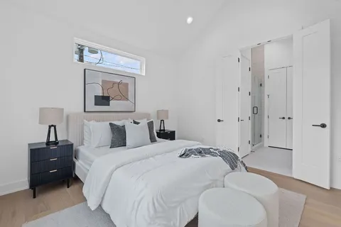 a bedroom with a bed and a painting on the wall