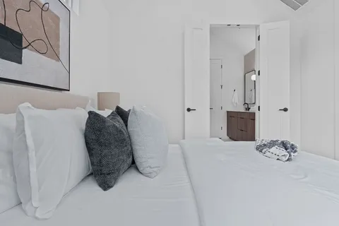 a large white bed in a white room