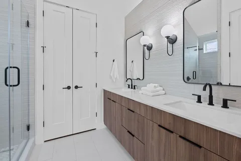 a bathroom with a double vanity sink and mirror