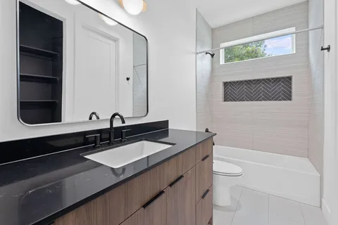 a bathroom with a sink a toilet and a bathtub