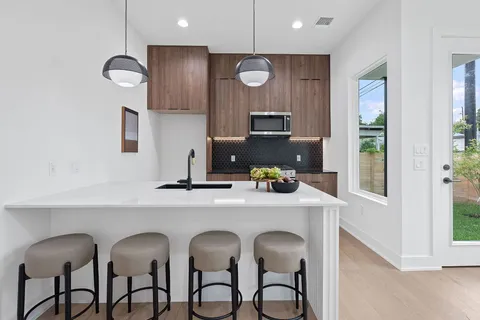 a kitchen with appliances cabinets and furniture