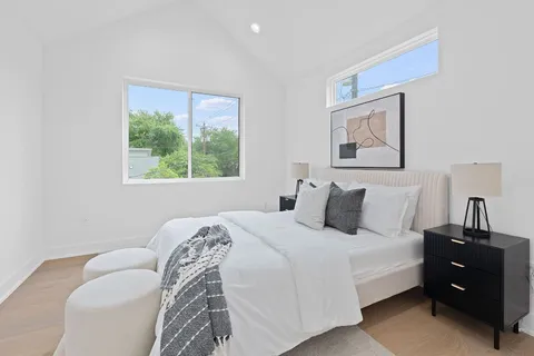 a bedroom with a bed and a window