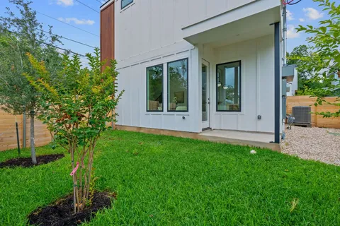 a view of house with backyard and garden