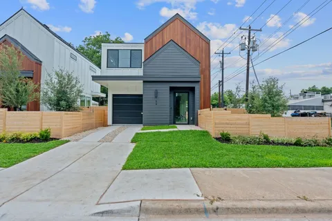 a view of a house with a yard and a garden