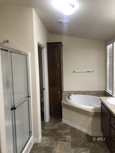 5651 South Kelso Valley Road Weldon, CA 93283 - Photo 13 of 34 a bathroom with a tub a sink and a large mirror