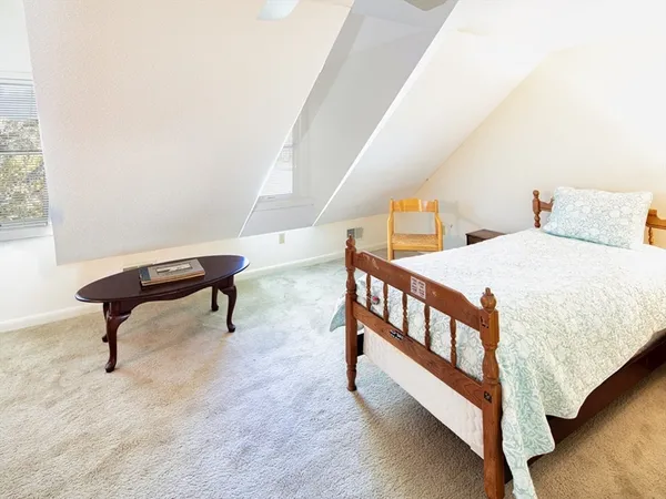 a bedroom with furniture and a window