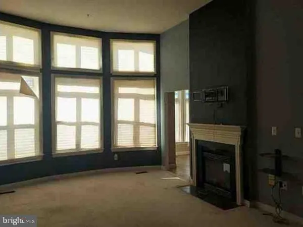 a view of an empty room with a fireplace