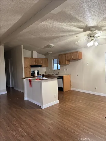 a view of kitchen with refrigerator stove microwave and cabinets