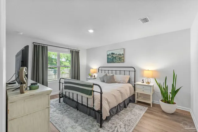 a bedroom with a bed and a couch