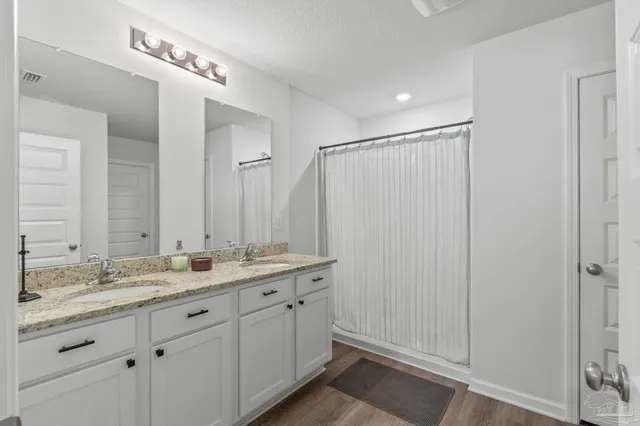 a bathroom with a double vanity sink and a mirror
