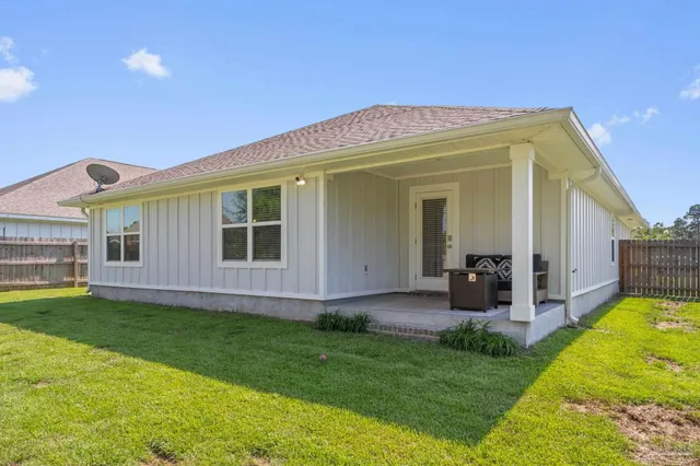 a view of a house with a yard and porch