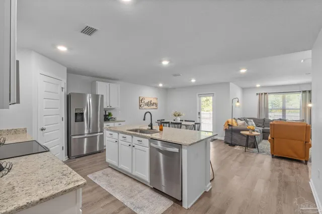 a kitchen with refrigerator and furniture