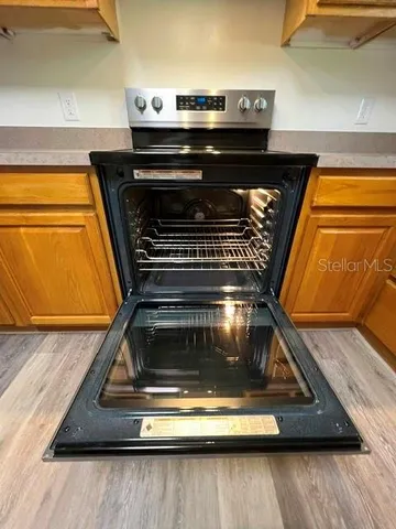 a stove top oven sitting inside of a kitchen