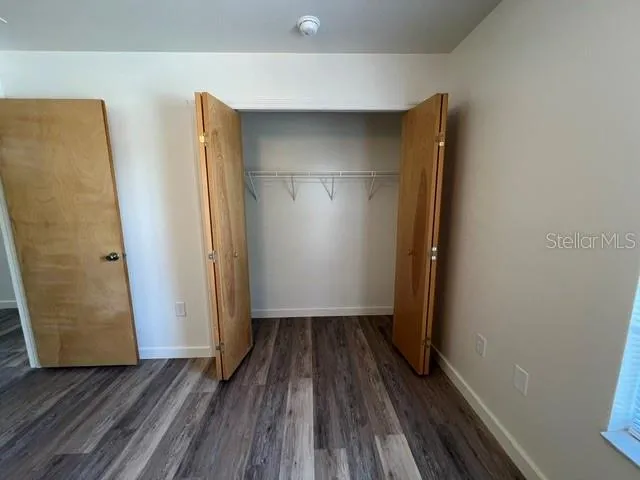 a view of room with wooden floor