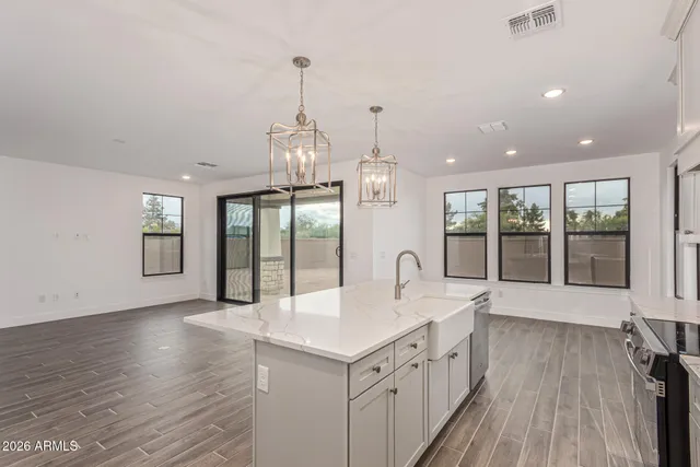 a large kitchen with stainless steel appliances kitchen island a large island in the center