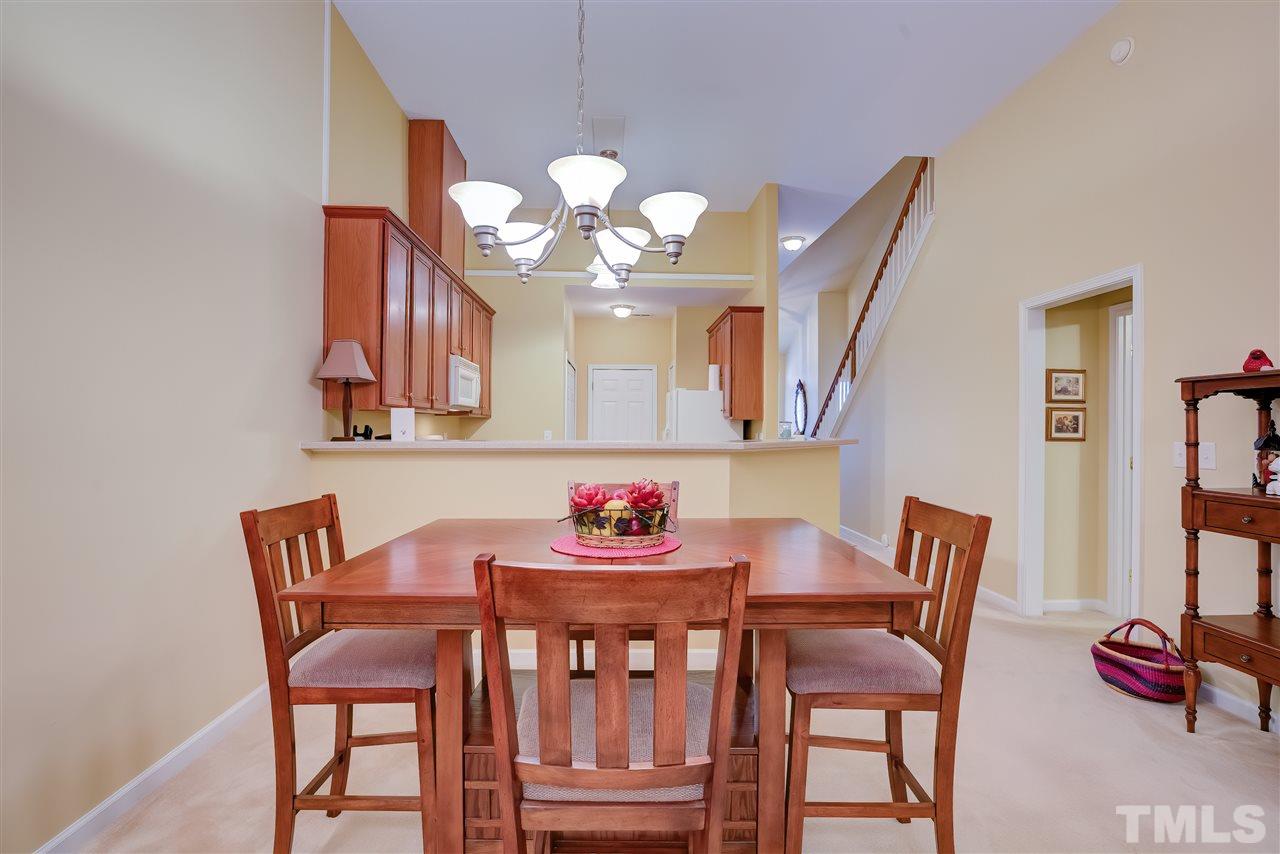 10305 Dapping Drive Raleigh, NC 27614 - Photo 11 of 30 a dining room with furniture and chandelier