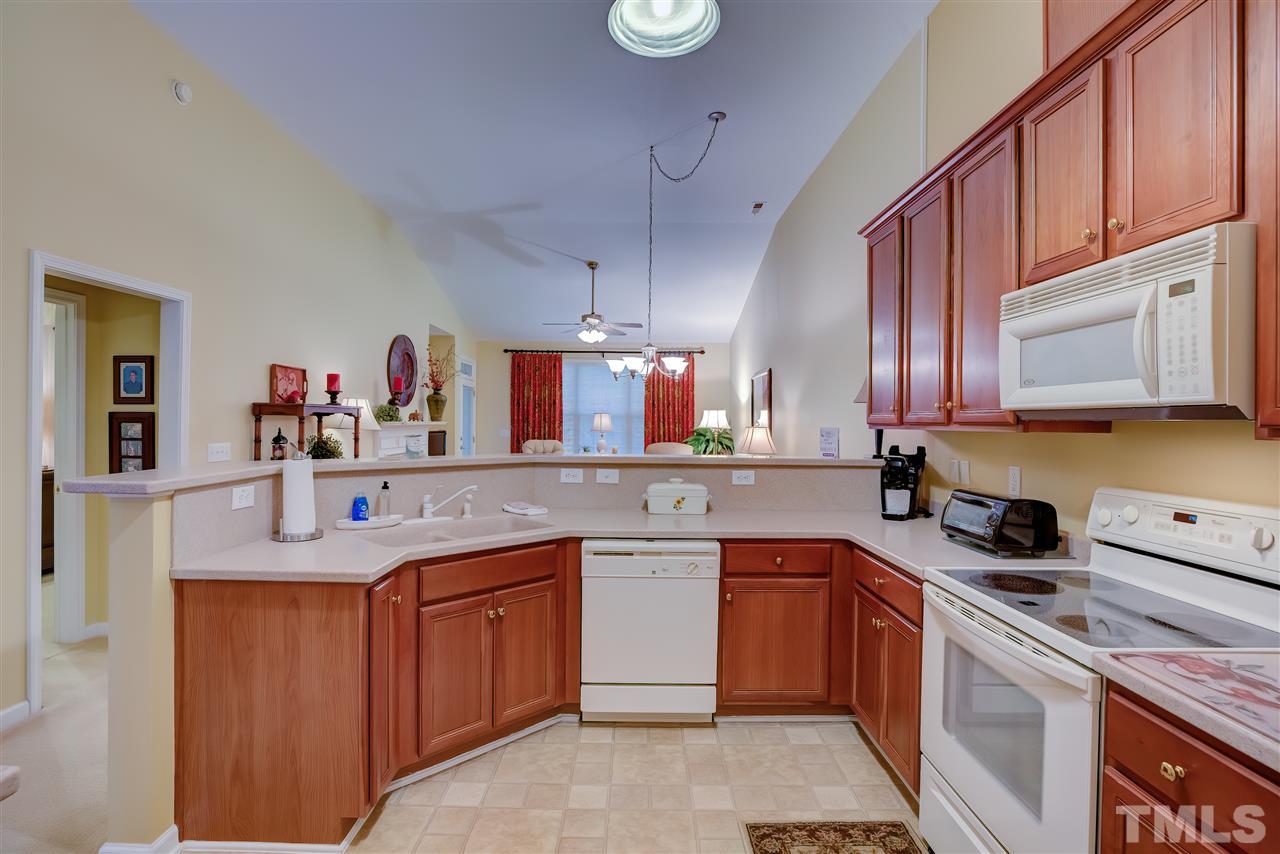 10305 Dapping Drive Raleigh, NC 27614 - Photo 12 of 30 a kitchen with a sink stove top oven and cabinets