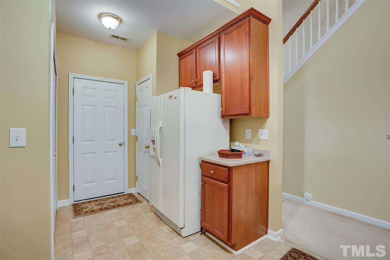 10305 Dapping Drive Raleigh, NC 27614 - Photo 15 of 30 a view of an empty room with fridge and wooden floor