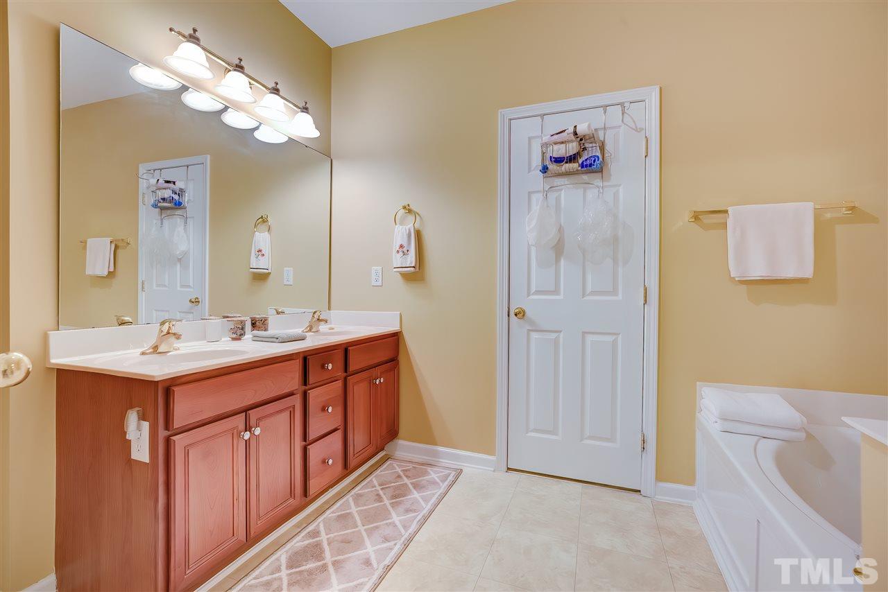 10305 Dapping Drive Raleigh, NC 27614 - Photo 18 of 30 a bathroom with a tub sink and mirror