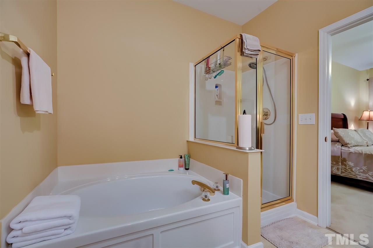 10305 Dapping Drive Raleigh, NC 27614 - Photo 19 of 30 a bathroom with a bathtub and a shower