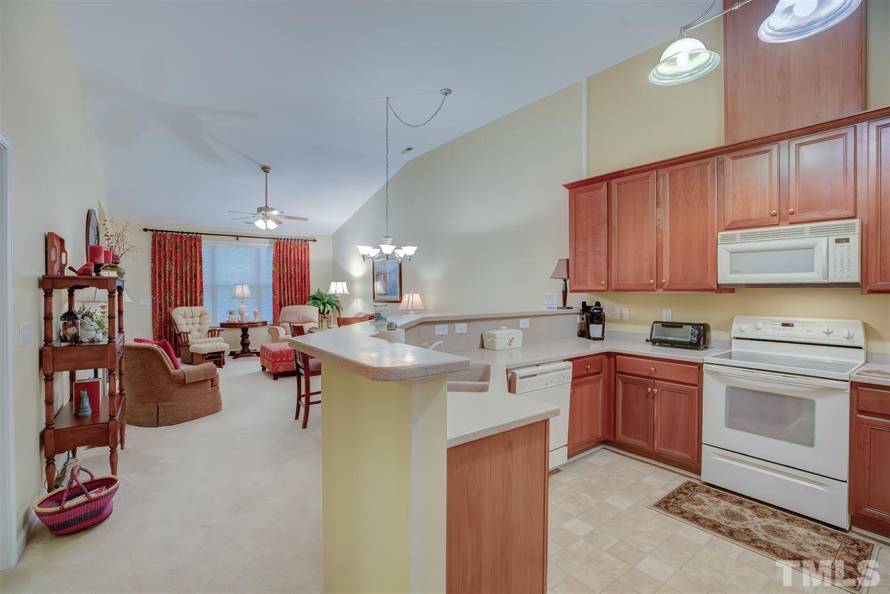 10305 Dapping Drive Raleigh, NC 27614 - Photo 6 of 30 a kitchen with a sink stove and cabinets