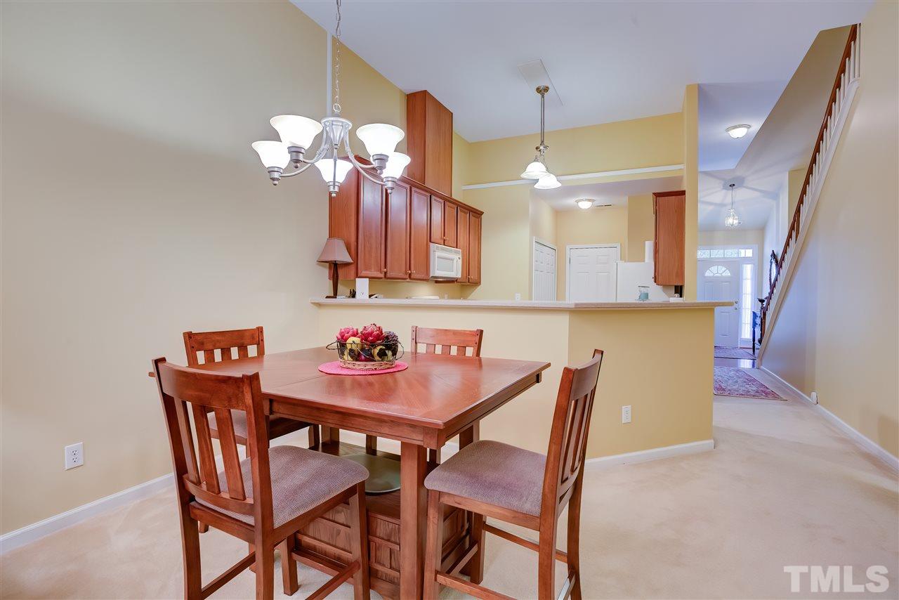 10305 Dapping Drive Raleigh, NC 27614 - Photo 10 of 30 a dining room filled chandelier and kitchen view