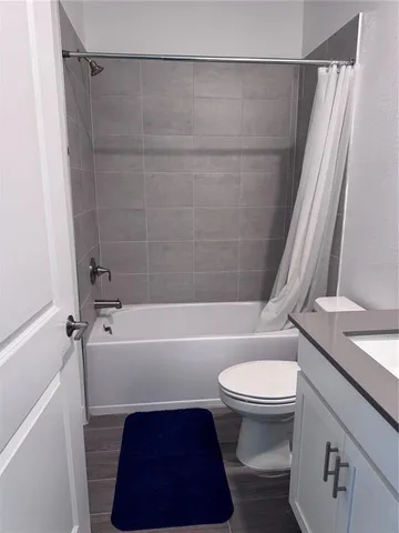 a bathroom with a toilet and a bathtub