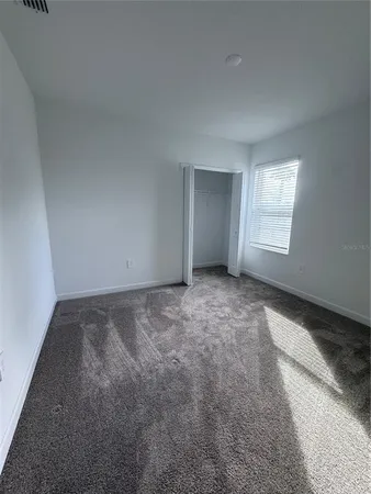 an empty room with a empty space and windows