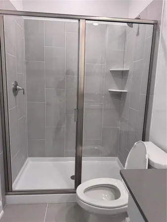 a bathroom with a shower and a toilet