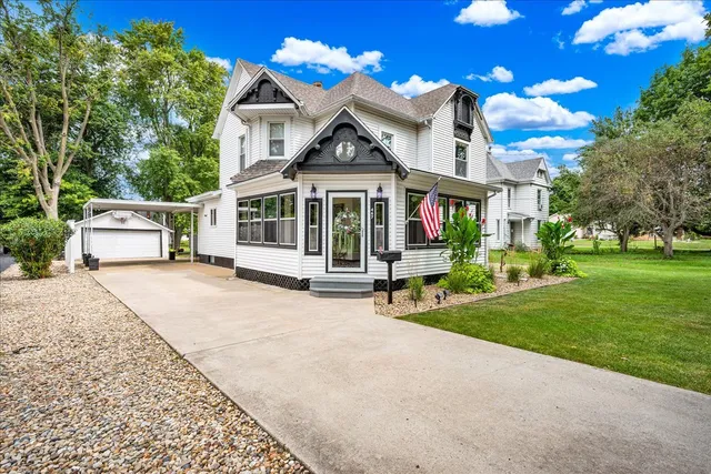 a view of a house with a yard and potted plants