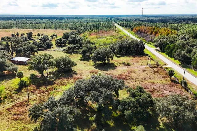 a view of a yard with wooden fence