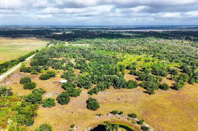 a view of a yard with wooden fence