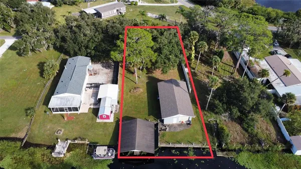 an aerial view of a residential houses with outdoor space
