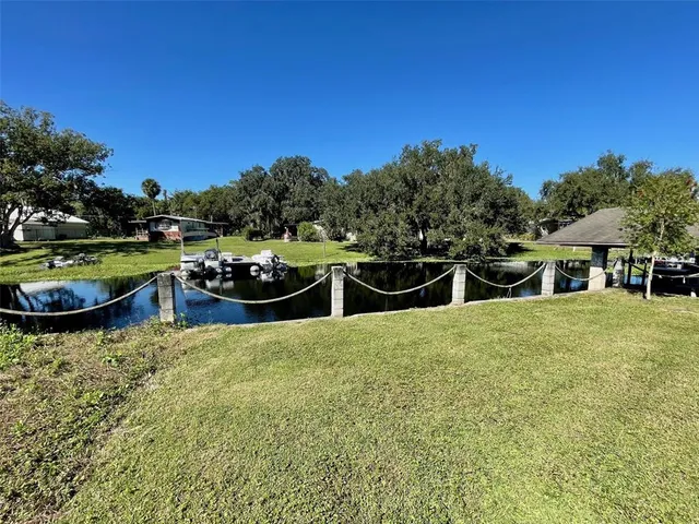 a swimming pool with plants and large trees