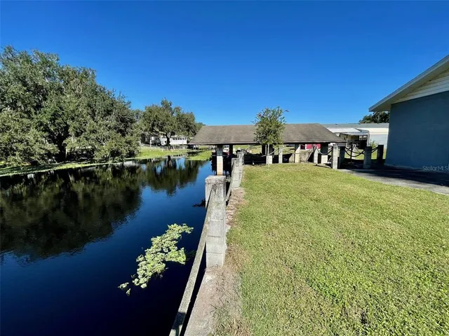 a view of a lake with a house in the background
