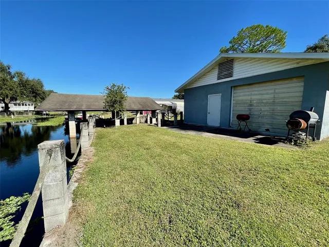 a view of a house with pool and chairs