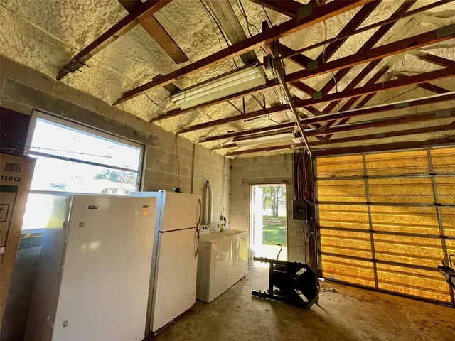 a view of room with refrigerator and window