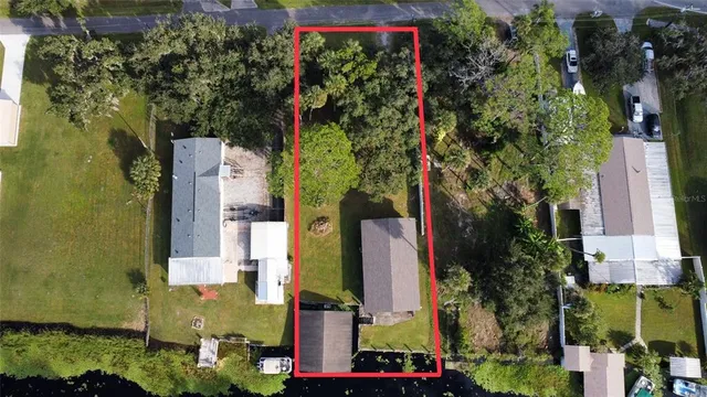 an aerial view of a residential apartment building with a yard and potted plants