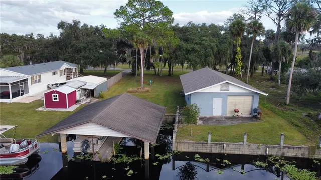 an aerial view of a house with swimming pool garden view and a patio